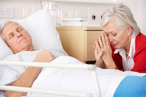 Senior woman with seriously ill husband in hospital