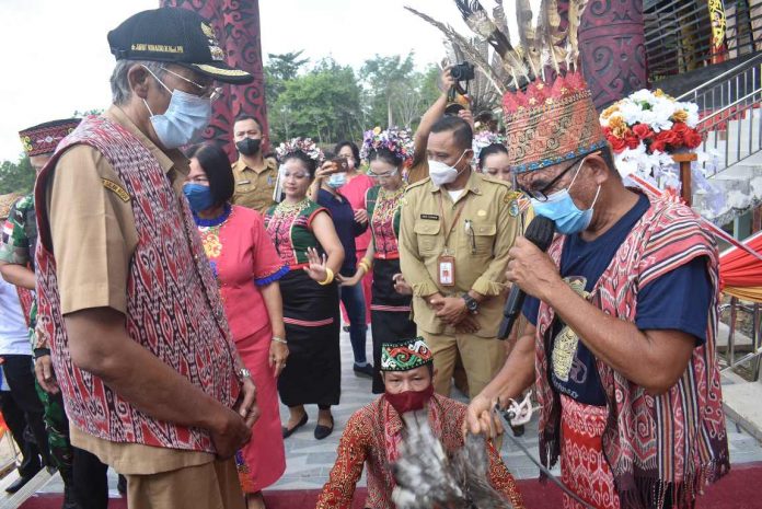 Bupati Kabupaten Sintang dr. Jarot Winarno disambut tetua masyarakat adat Sintang sebelum melakukan seremoni peresmian Rumah Betang Kabupaten Sintang. (Victor Emanuel)